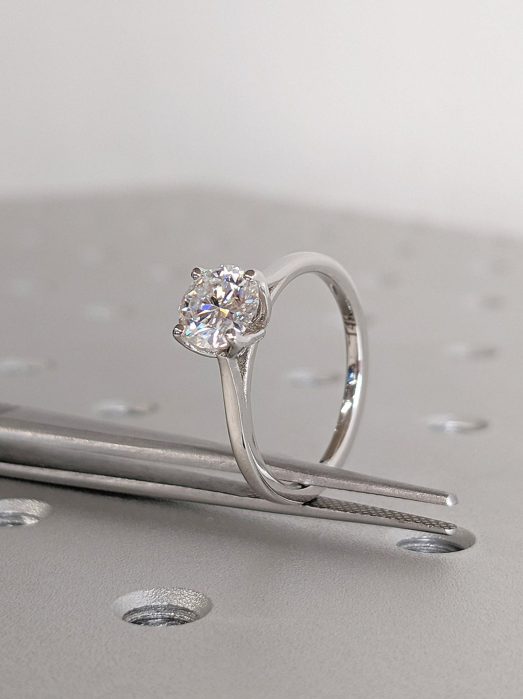 Close-up of round cut center diamond in solitaire engagement ring