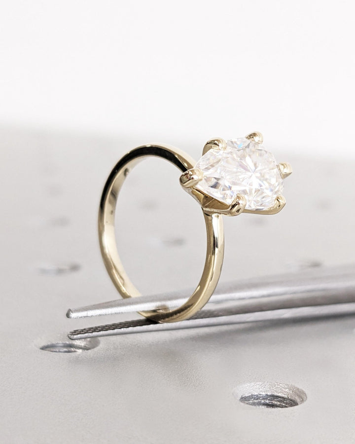 Pear solitaire diamond ring presented in signature gift packaging