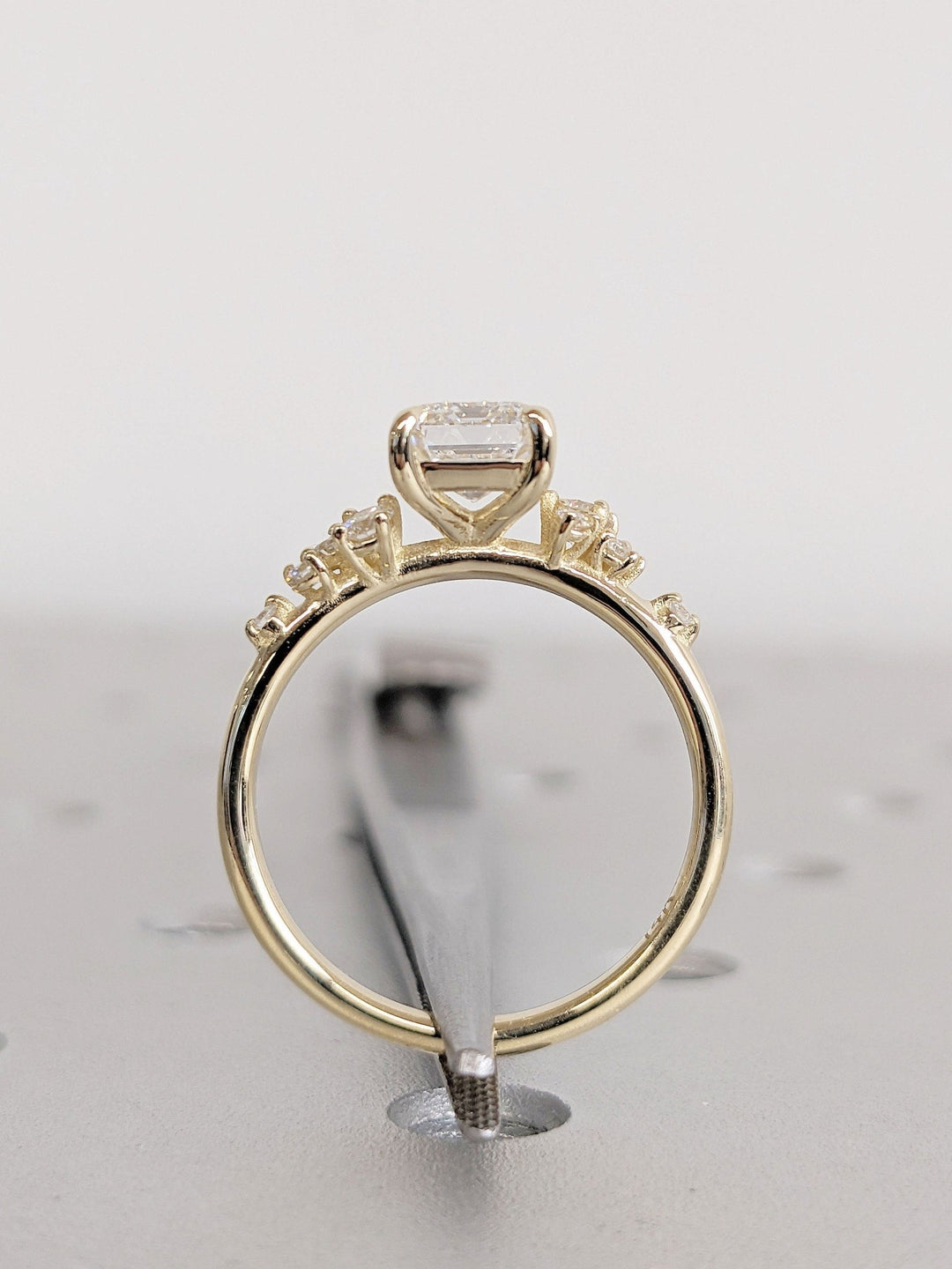 Fine craftsmanship detail on emerald cluster engagement ring