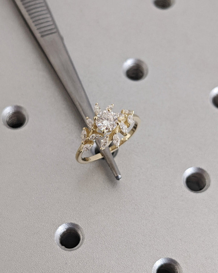 Round cut cluster engagement ring shown in real-life wear
