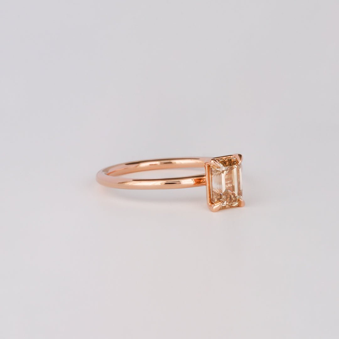 Emerald solitaire diamond ring presented in signature gift packaging