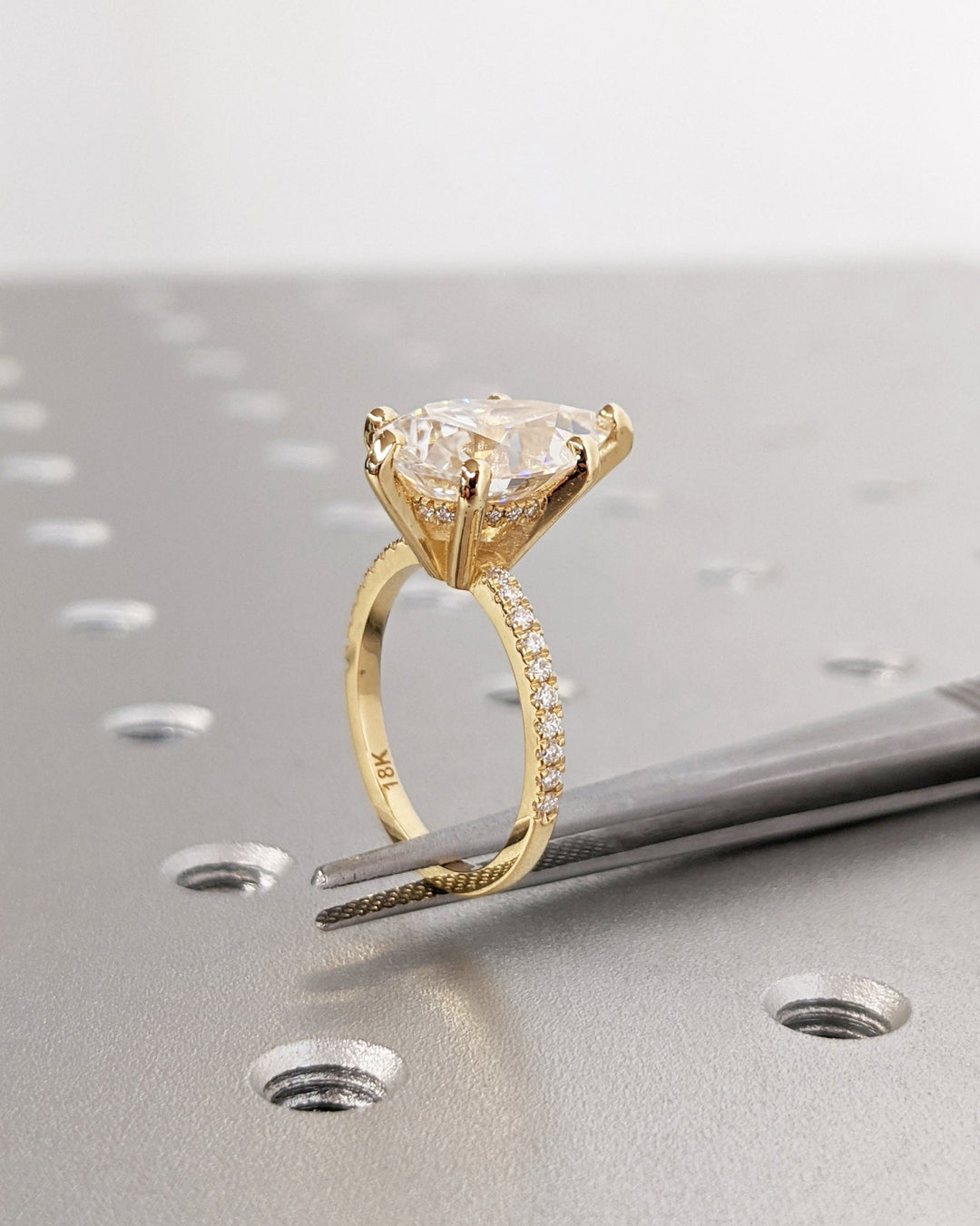Top-down view of pear cut hidden halo engagement ring