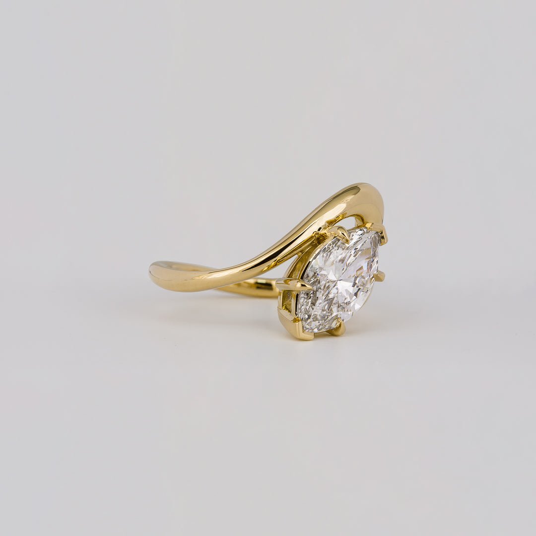 Detailed close-up of marquise solitaire diamond engagement ring