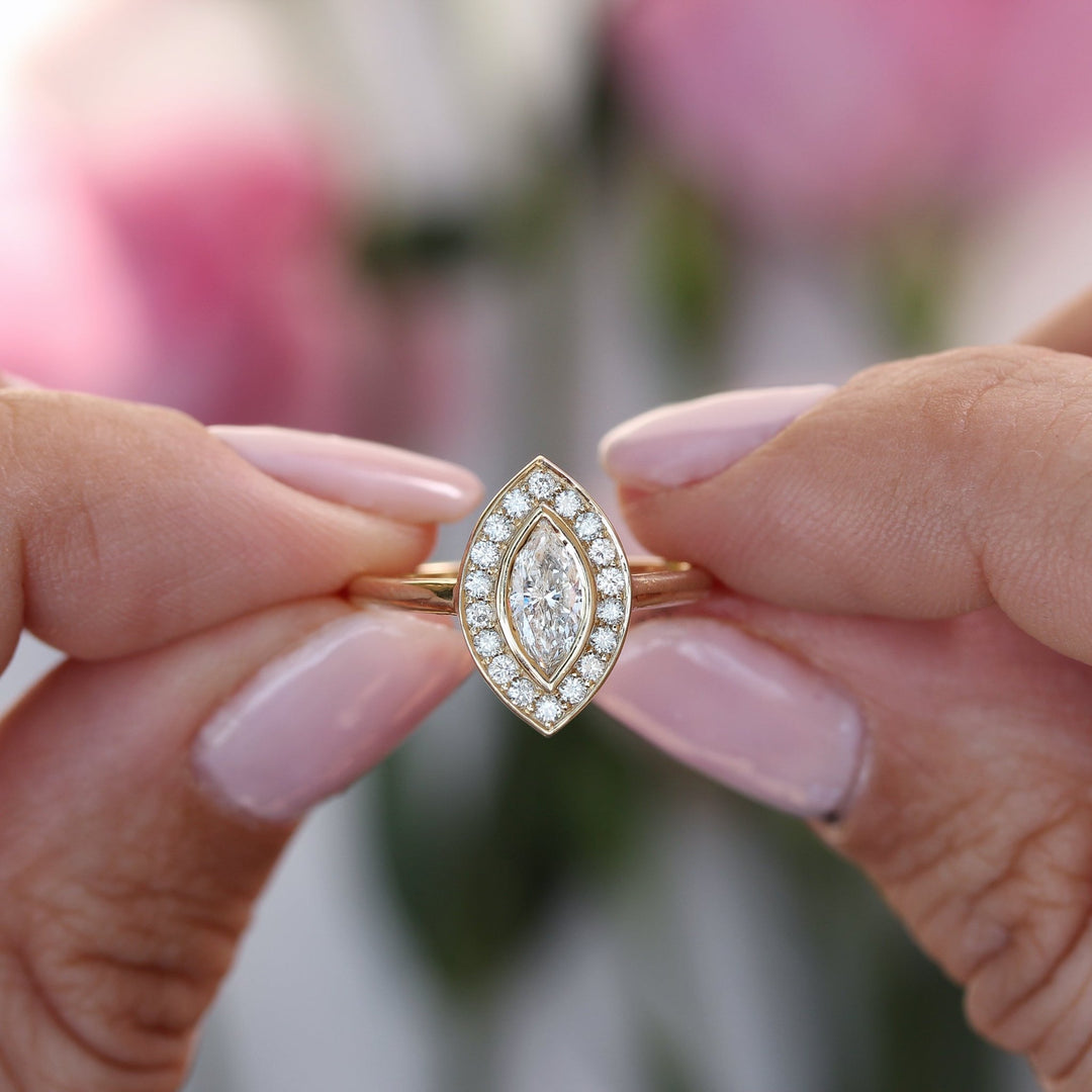Certified marquise cut diamond featured in halo engagement ring