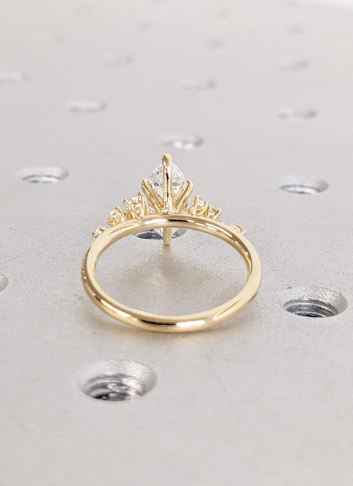 Detailed close-up of marquise cluster diamond engagement ring