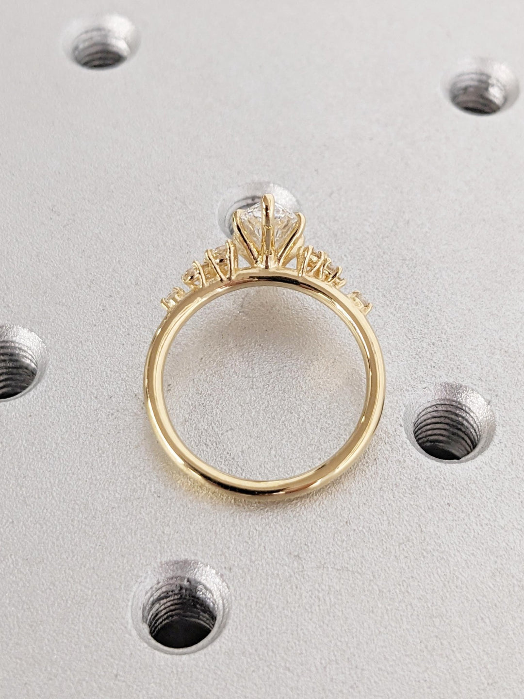 Macro shot of marquise cut diamond facets in cluster ring setting