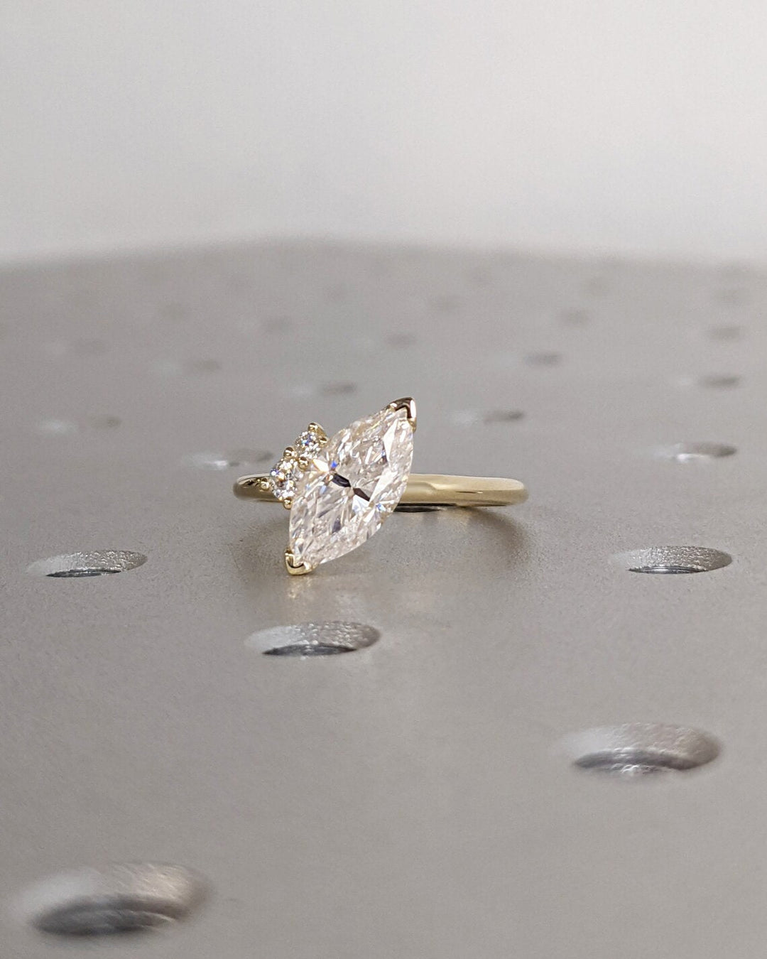 Certified marquise cut diamond featured in cluster engagement ring