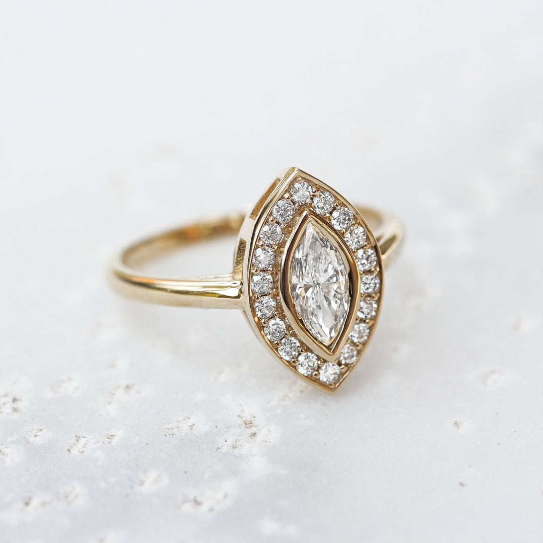 IGI certified marquise cut diamond in halo engagement ring setting