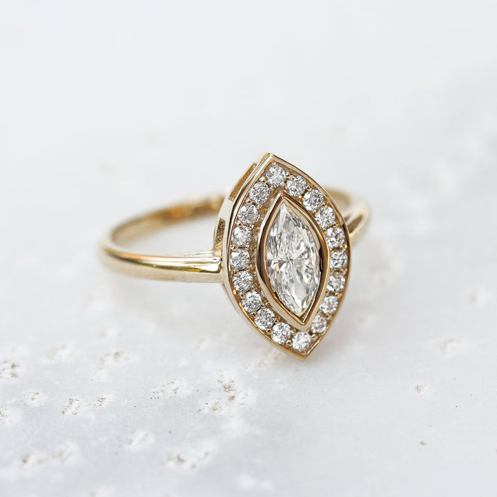 IGI certified marquise cut diamond in halo engagement ring setting
