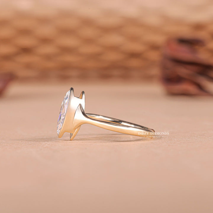 Unboxing view of marquise cut bezel diamond engagement ring