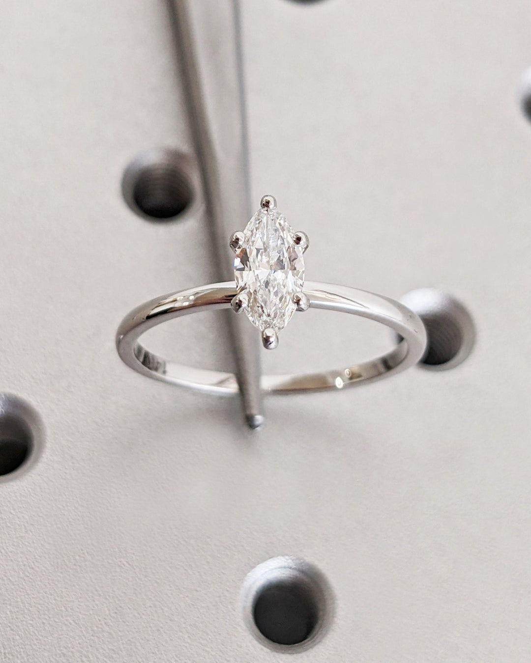 Marquise solitaire lab grown diamond ring side profile in gold setting
