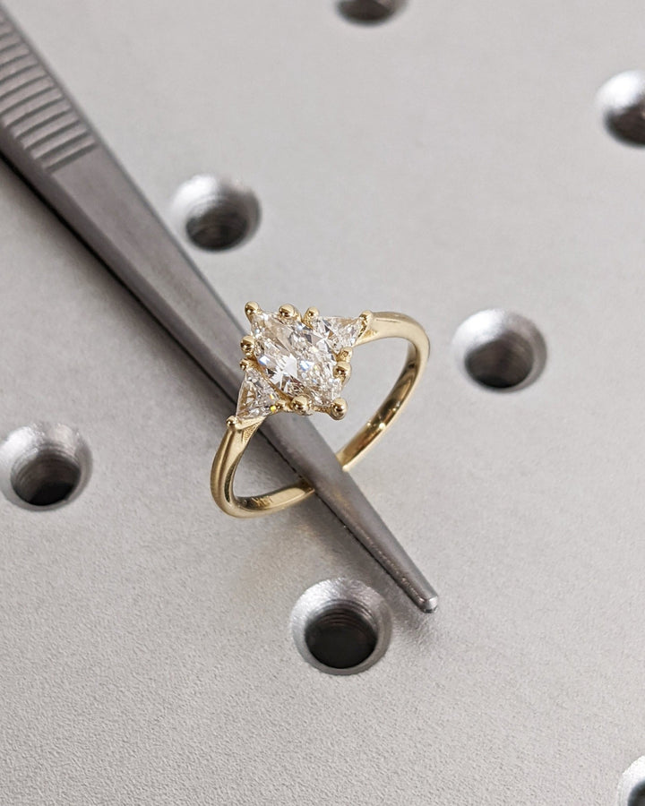 Marquise solitaire engagement ring shown on hand for true-to-life sizing