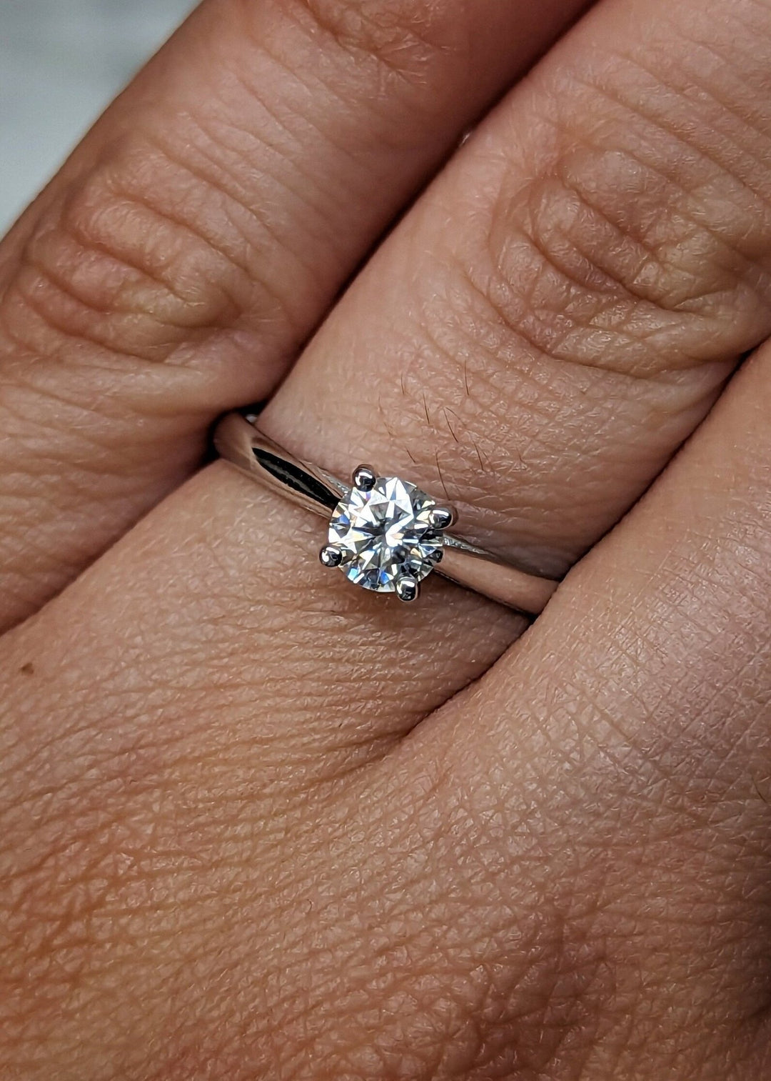 Profile view of round cut solitaire engagement ring band