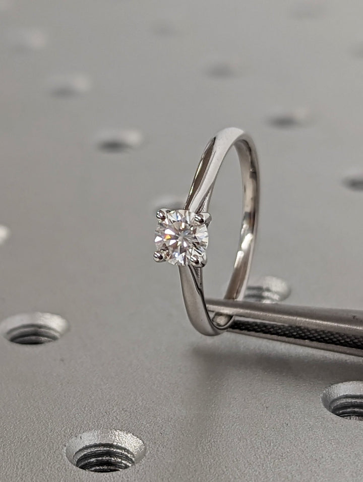 Round cut diamond ring worn on hand