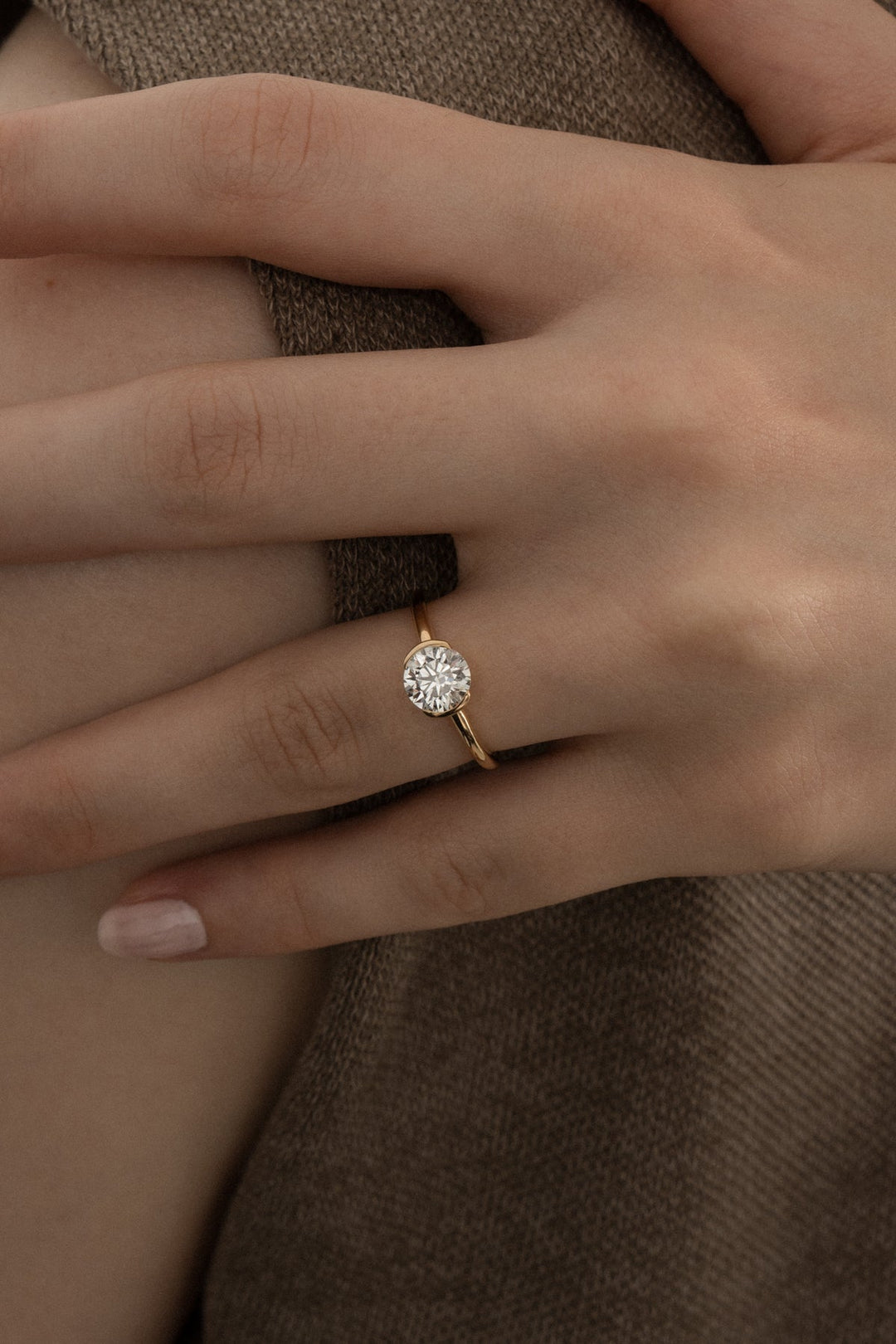 Round bezel engagement ring close-up showing high clarity diamond clarity