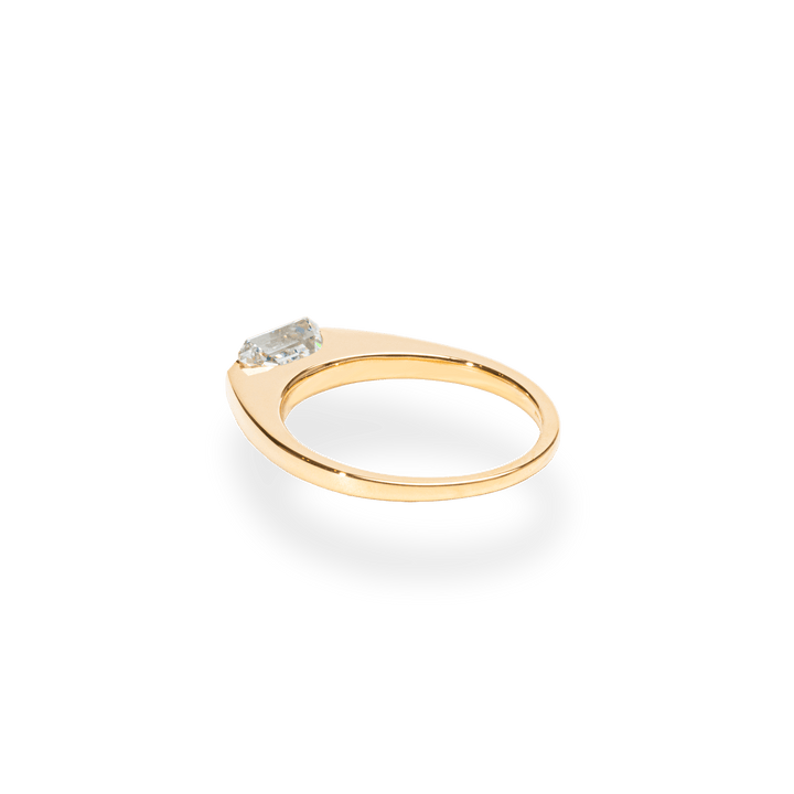 Emerald east west engagement ring offered in gold and platinum