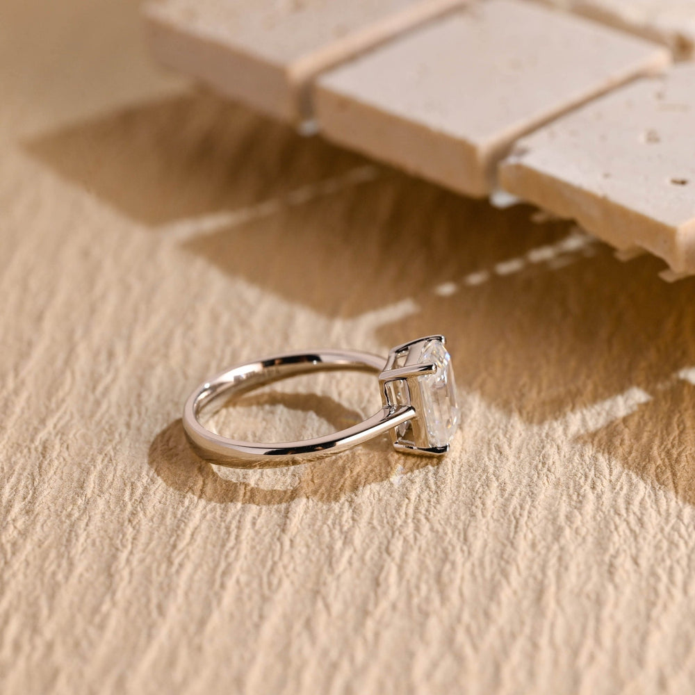 Emerald solitaire engagement ring offered in gold and platinum
