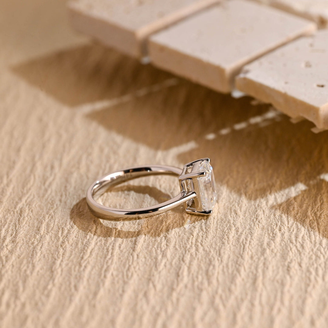 Emerald solitaire engagement ring offered in gold and platinum
