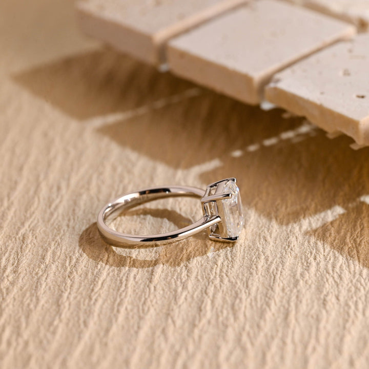 Emerald solitaire engagement ring offered in gold and platinum
