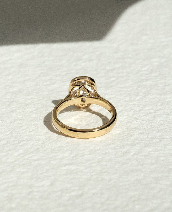 Premium cushion cut bezel engagement ring crafted in solid gold