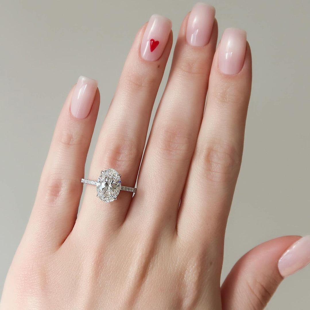 Certified oval cut diamond featured in pave engagement ring