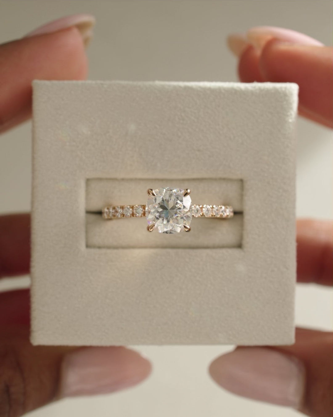 Detailed close-up of cushion hidden halo diamond engagement ring
