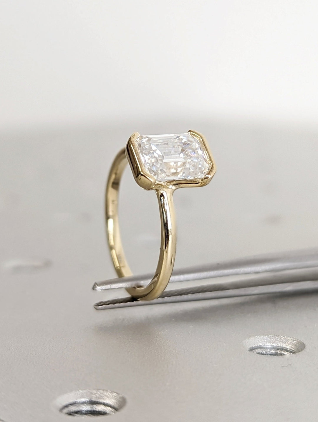 Emerald bezel engagement ring close-up showing high clarity diamond clarity