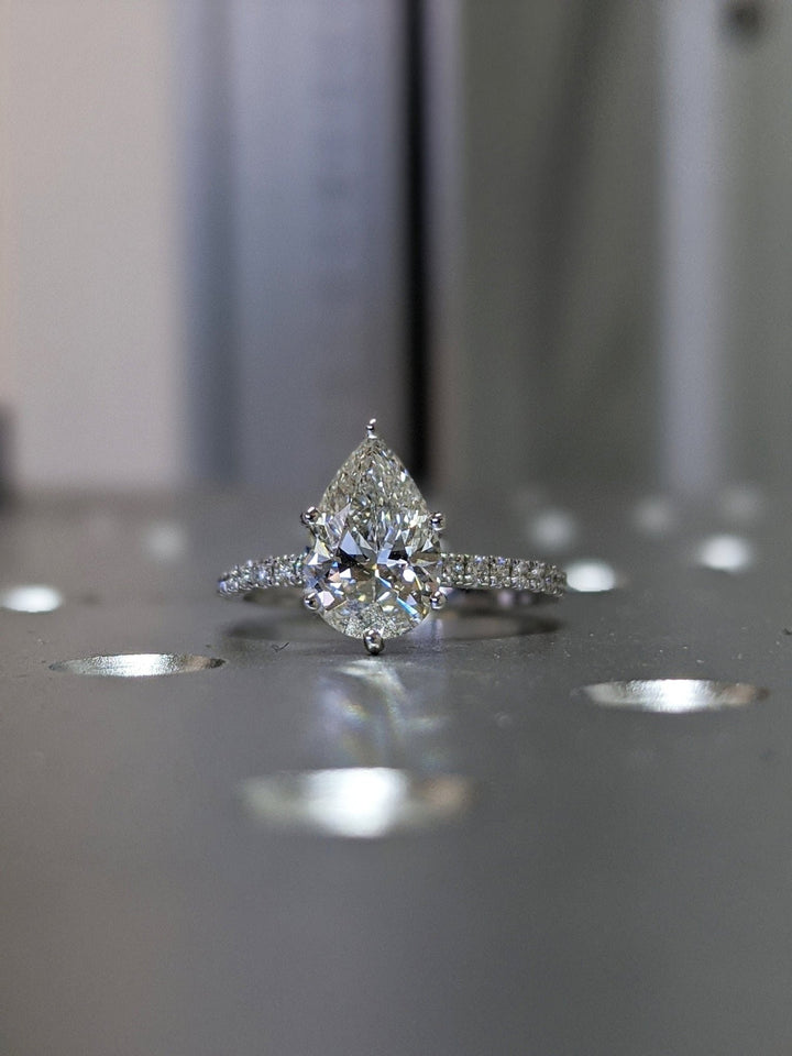 Pear cut pave engagement ring with IGI certified center diamond