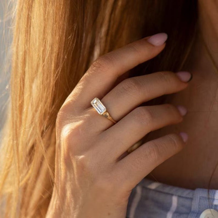 Emerald east west lab grown diamond ring side profile in gold setting
