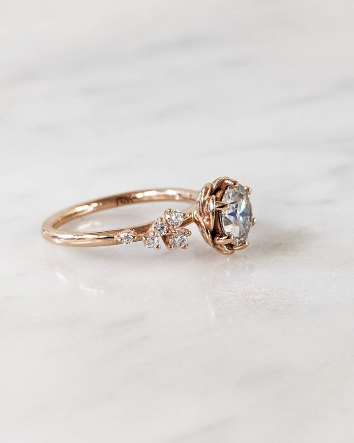 Round cut cluster engagement ring shown in real-life wear