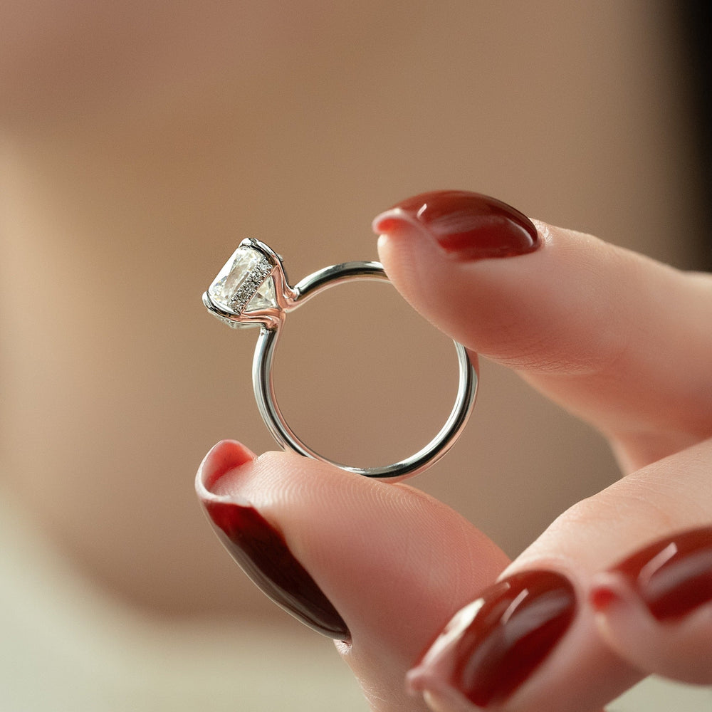 Cushion hidden halo engagement ring offered in gold and platinum