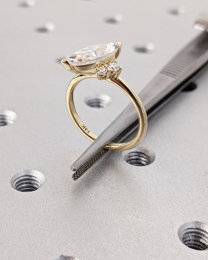 Marquise cut cluster engagement ring with IGI certified center diamond