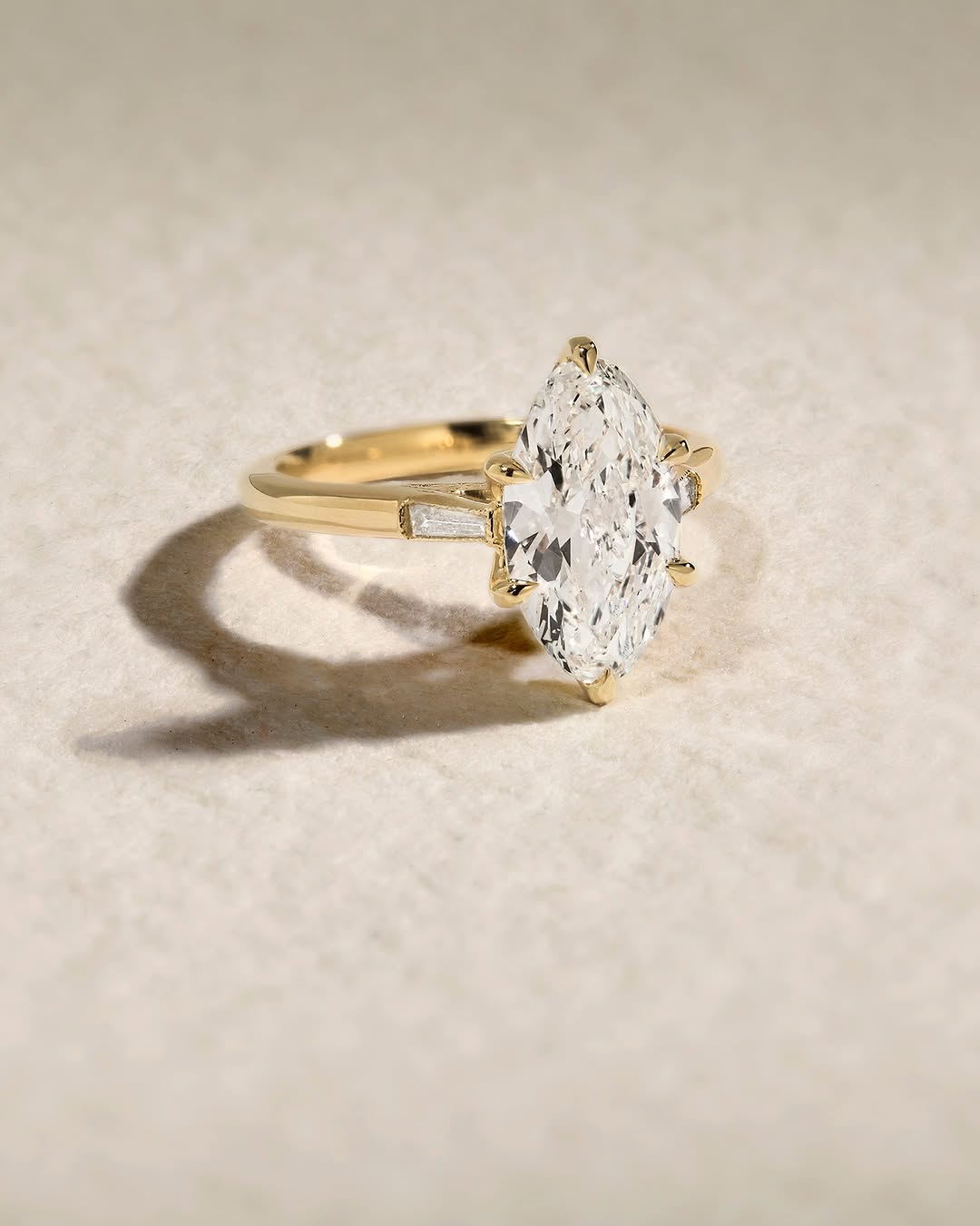 Marquise three stone engagement ring offered in gold and platinum