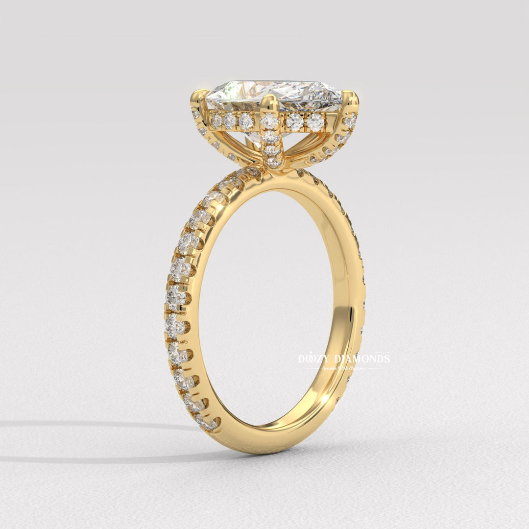 Pear hidden halo engagement ring finished in polished solid gold