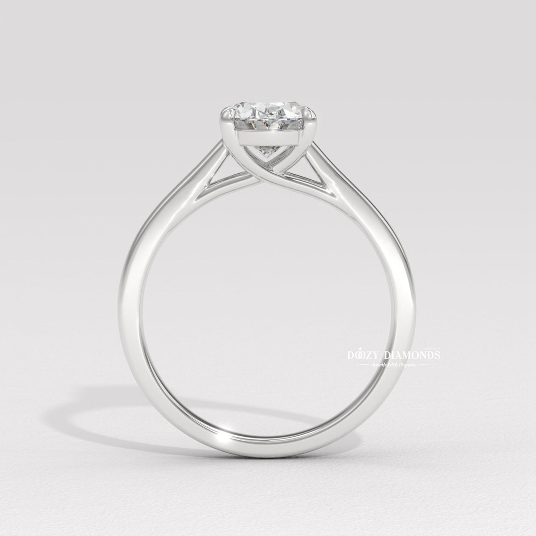 Oval solitaire diamond ring displayed on jewelry stand