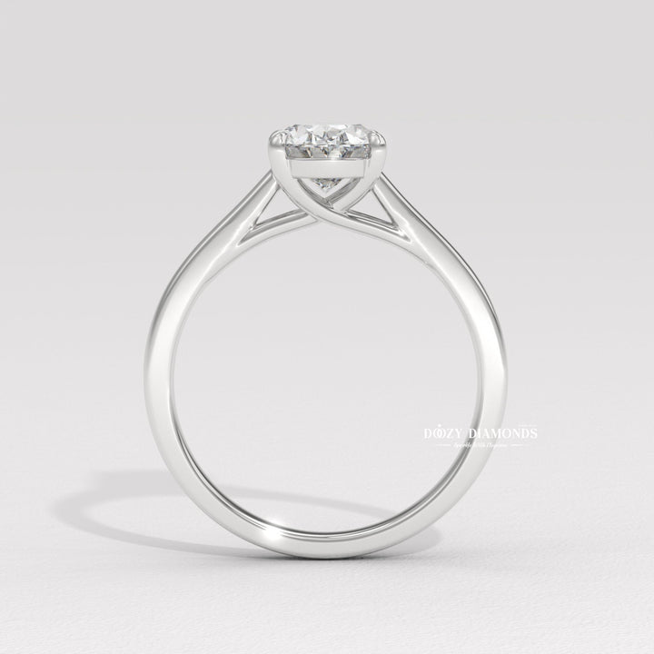Oval solitaire diamond ring displayed on jewelry stand