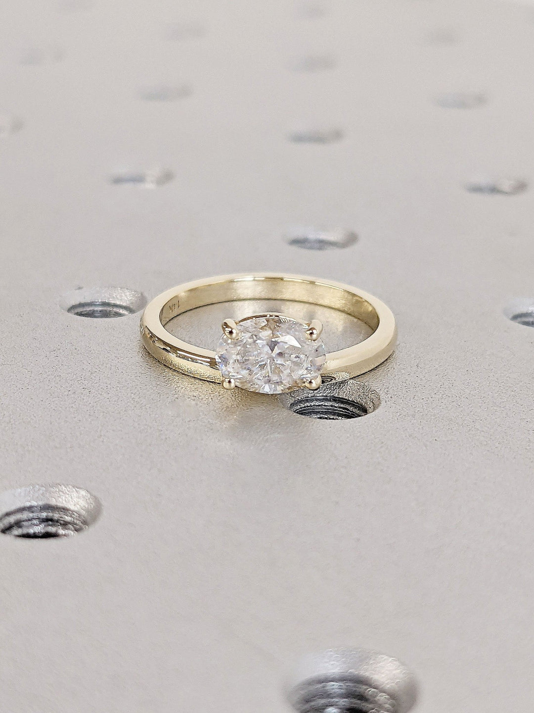 Oval east west engagement ring close-up highlighting diamond sparkle