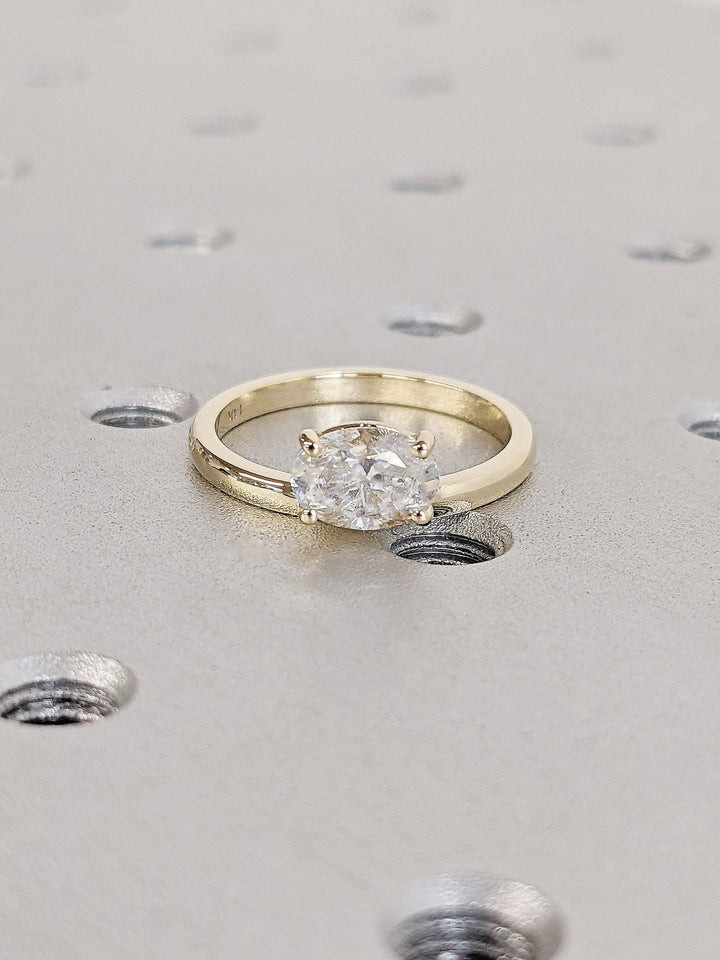 Oval east west engagement ring close-up highlighting diamond sparkle