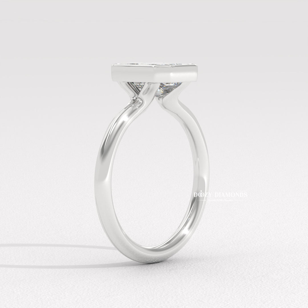 Side angle of emerald bezel diamond engagement ring