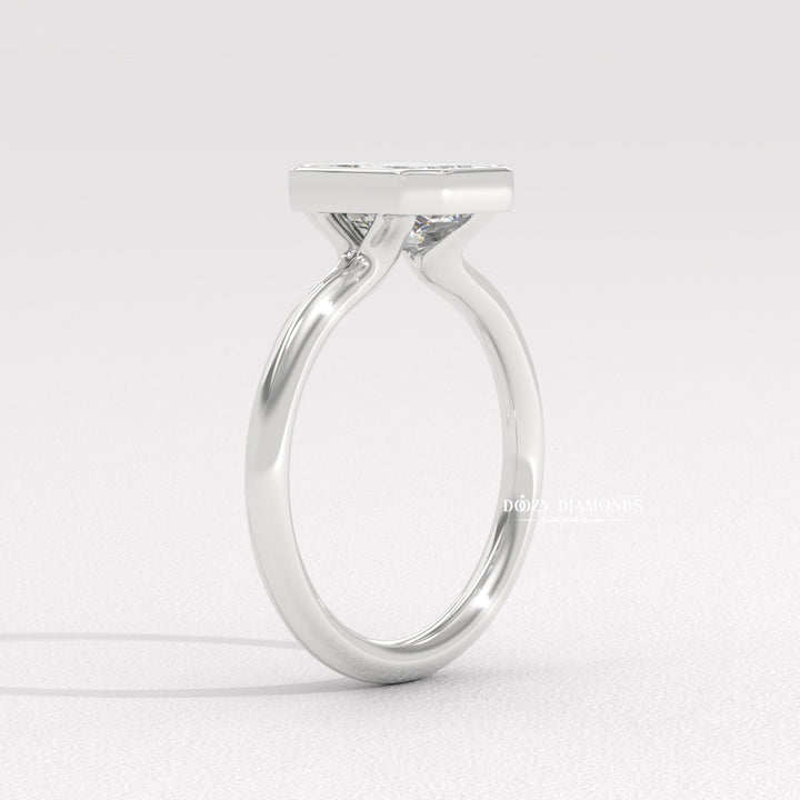 Side angle of emerald bezel diamond engagement ring