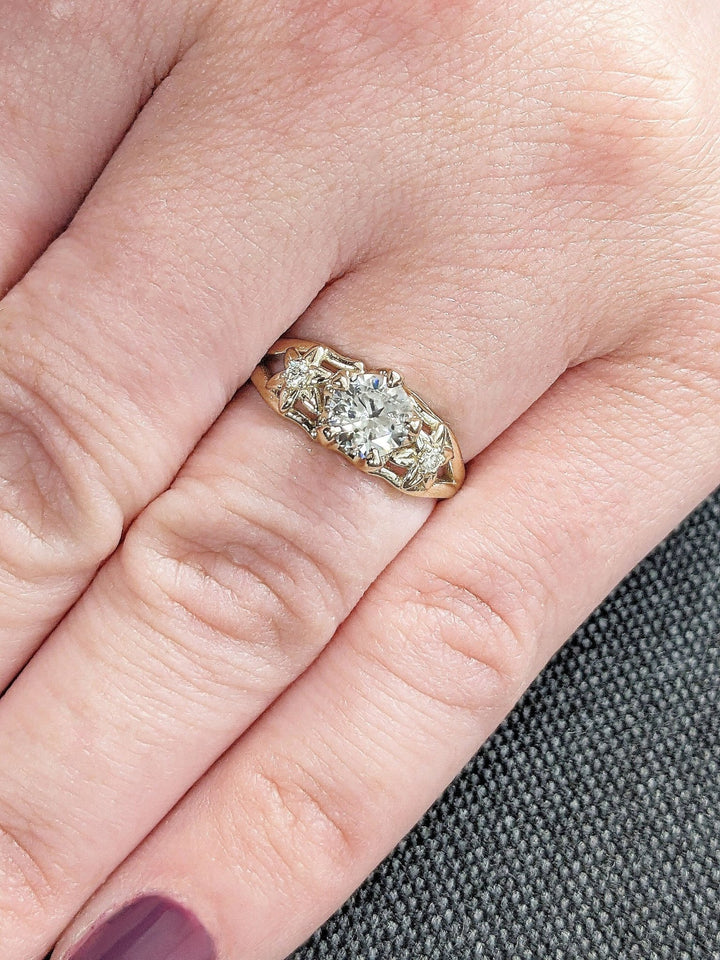 Round cut engagement ring shown with authenticity certificate