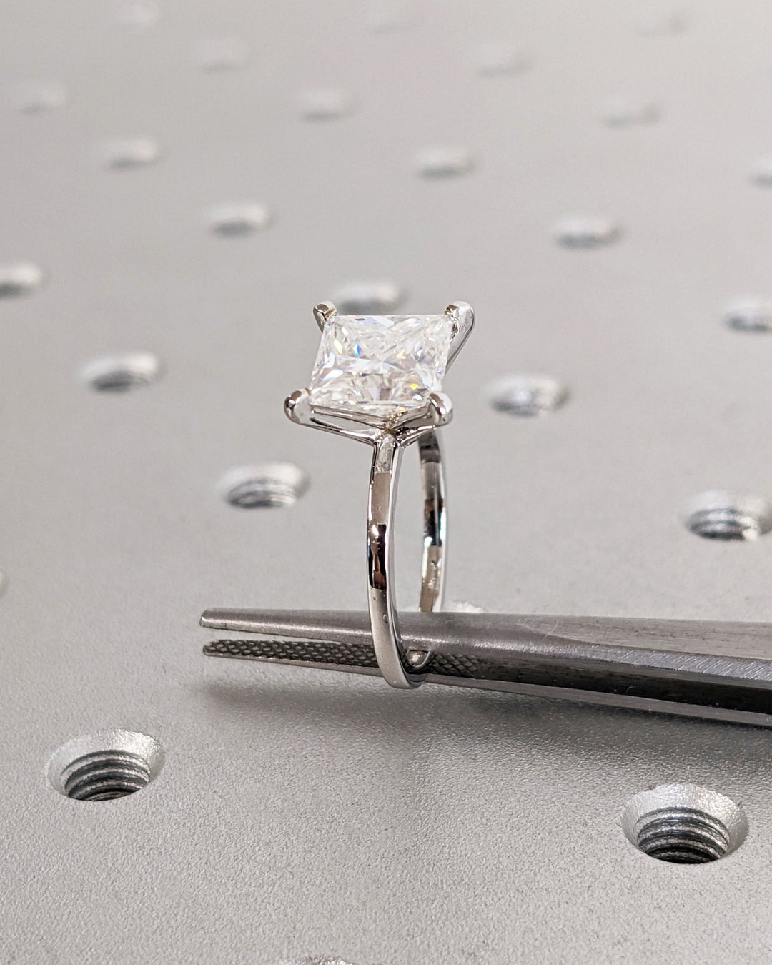 Unboxing view of princess cut solitaire diamond engagement ring