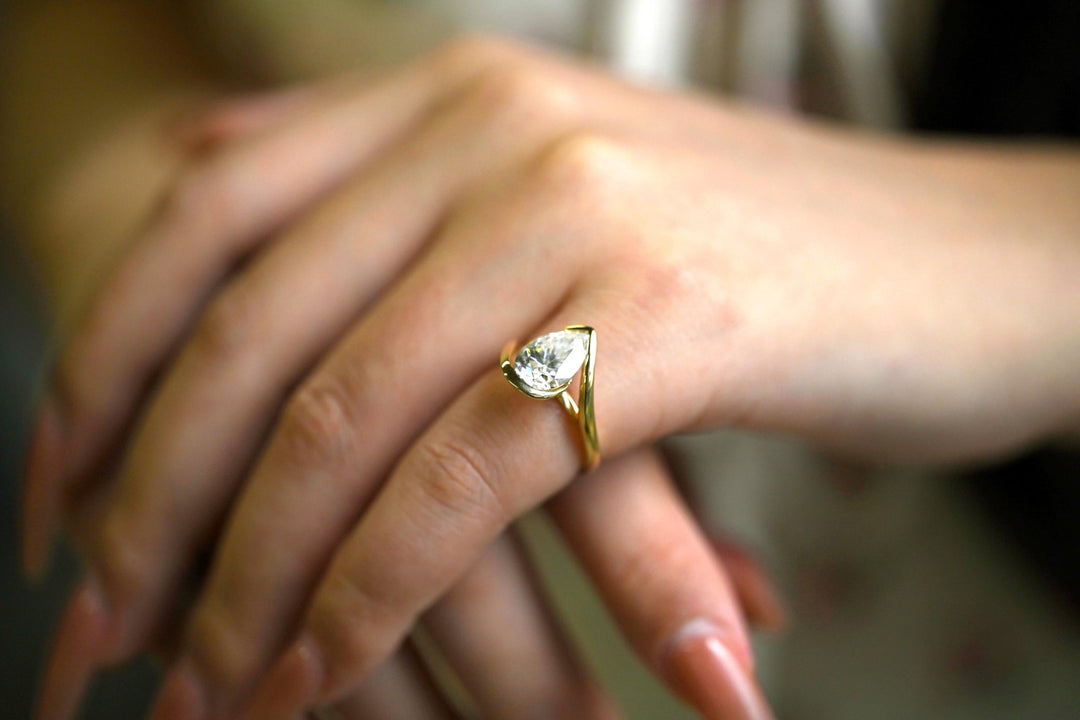 Pear cut solitaire engagement ring shown in real-life wear