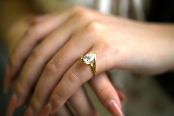 Pear cut solitaire engagement ring shown in real-life wear