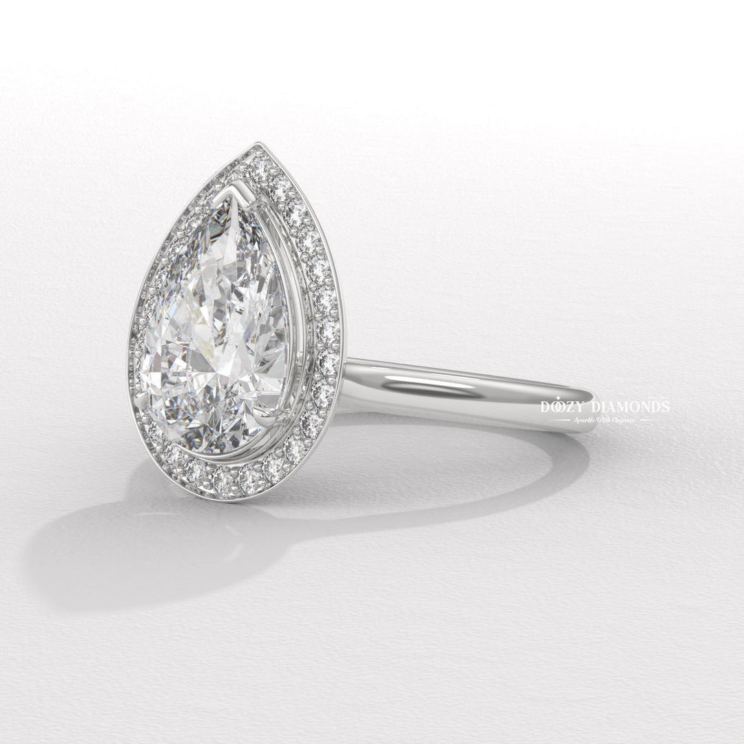 Pear halo engagement ring photographed in natural light