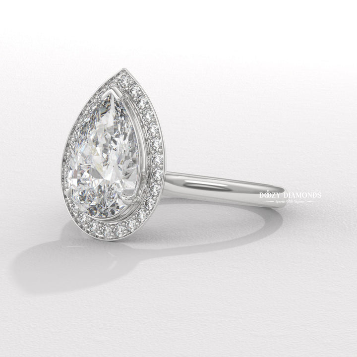 Pear halo engagement ring photographed in natural light