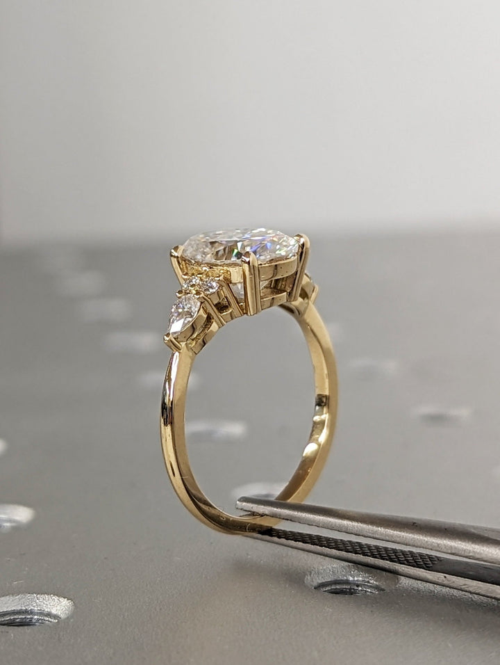 Side angle of oval cluster diamond engagement ring