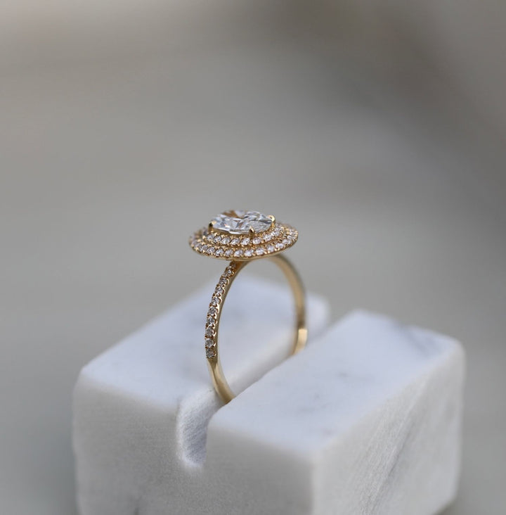 Oval halo lab grown diamond ring fitted on finger