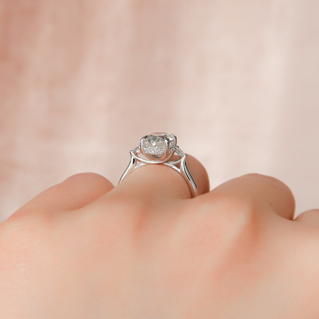 IGI certified oval cut diamond in three stone engagement ring setting