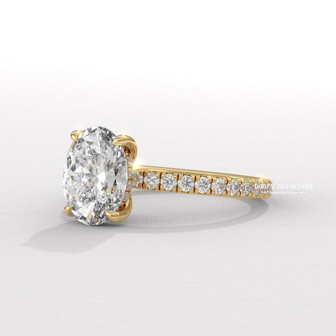 Oval hidden halo engagement ring offered in gold and platinum